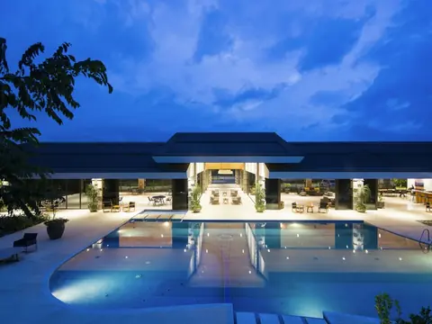 Hotel pool lit up at dusk