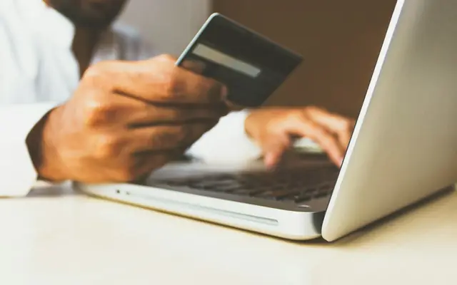 Paying by card on a laptop during online checkout